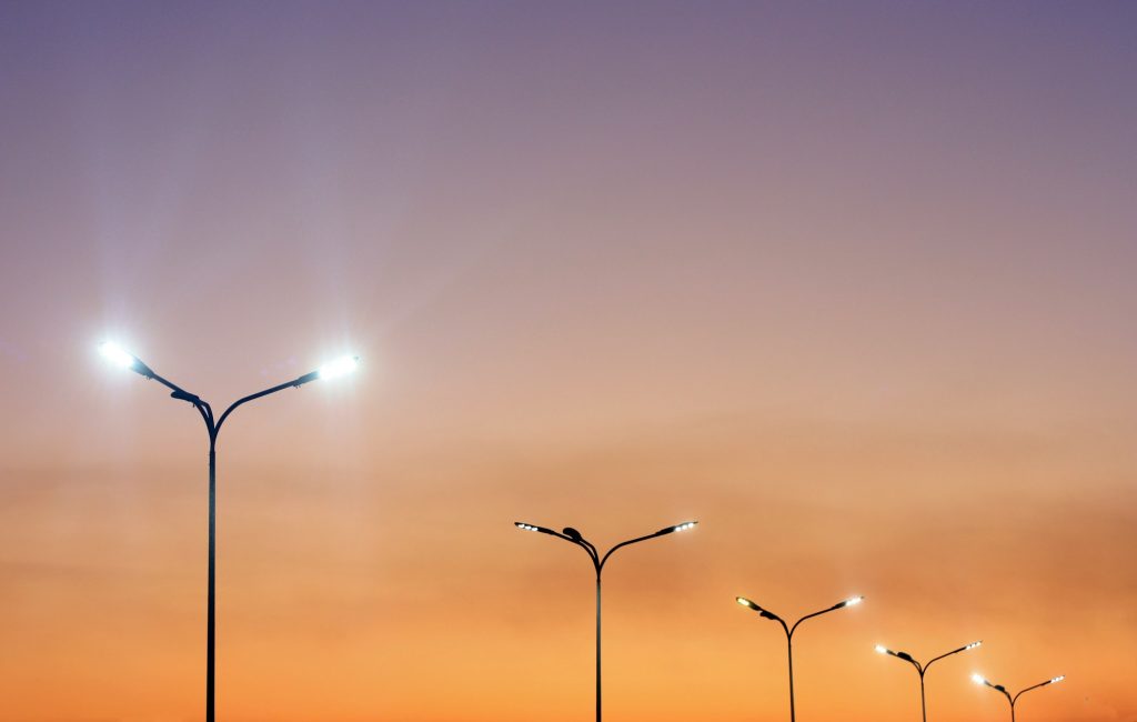 Urban landscape with modern minimal street lights and vibrant sky.